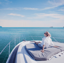 Woman sitting on the front of a ship