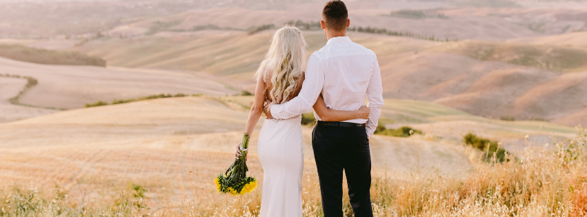 Wedding couple looking over fields